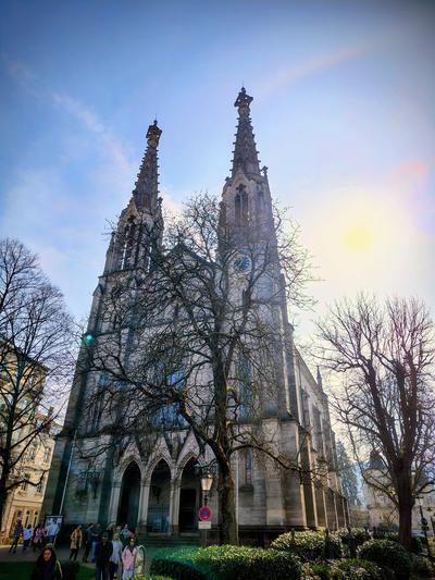 A Gothic spire over the old town, caught against a bright March sky