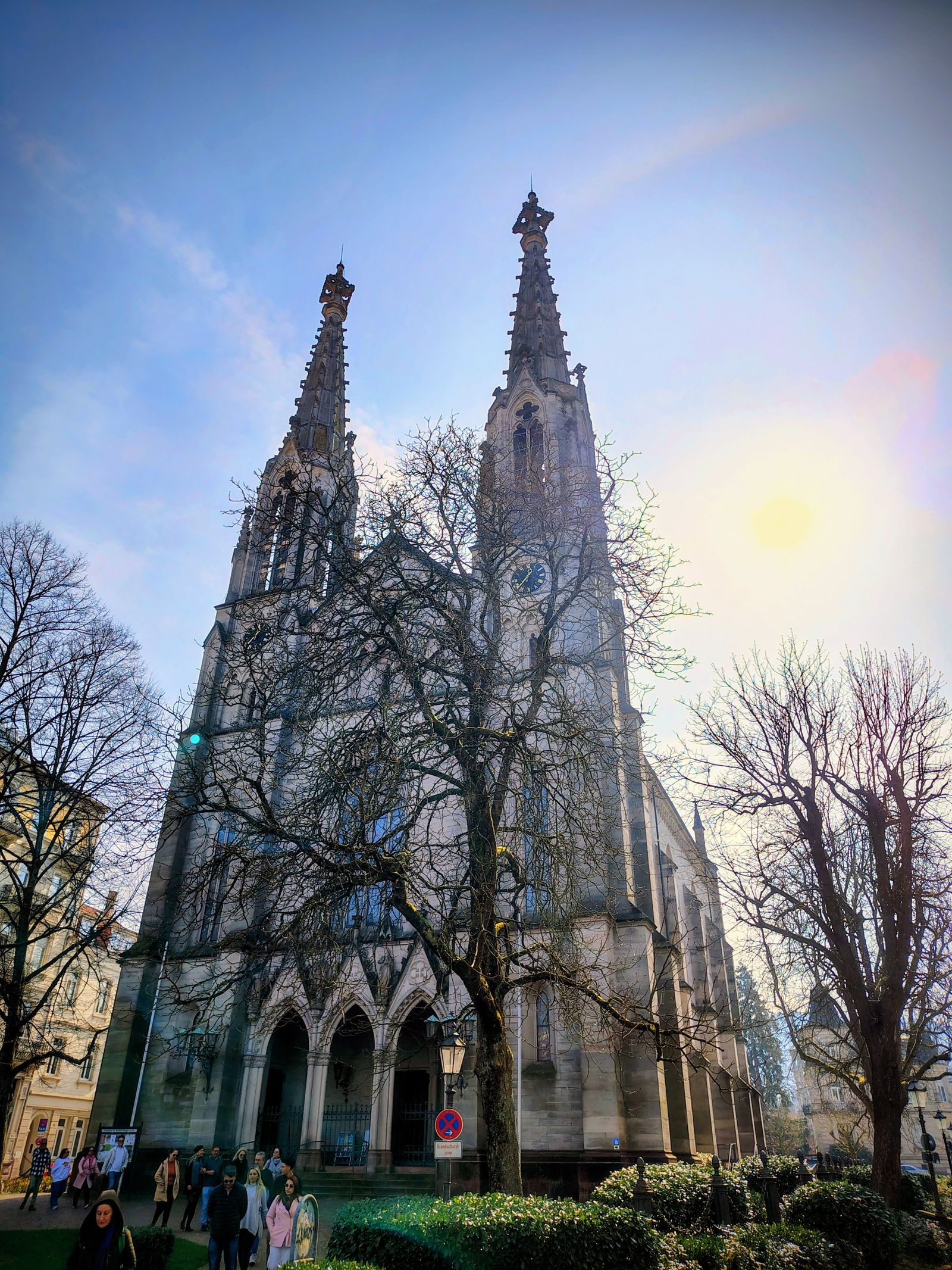 A Gothic spire over the old town, caught against a bright March sky