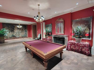 The billiard room at Brenners — red walls, a tapestry, and nobody playing