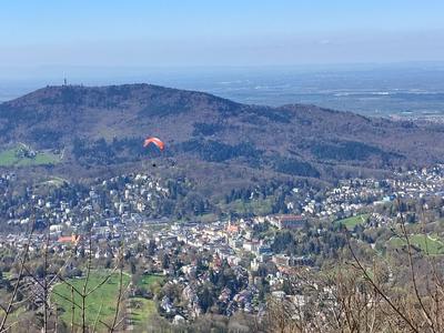 The Black Forest ridge above the town, with a paraglider off the Merkur