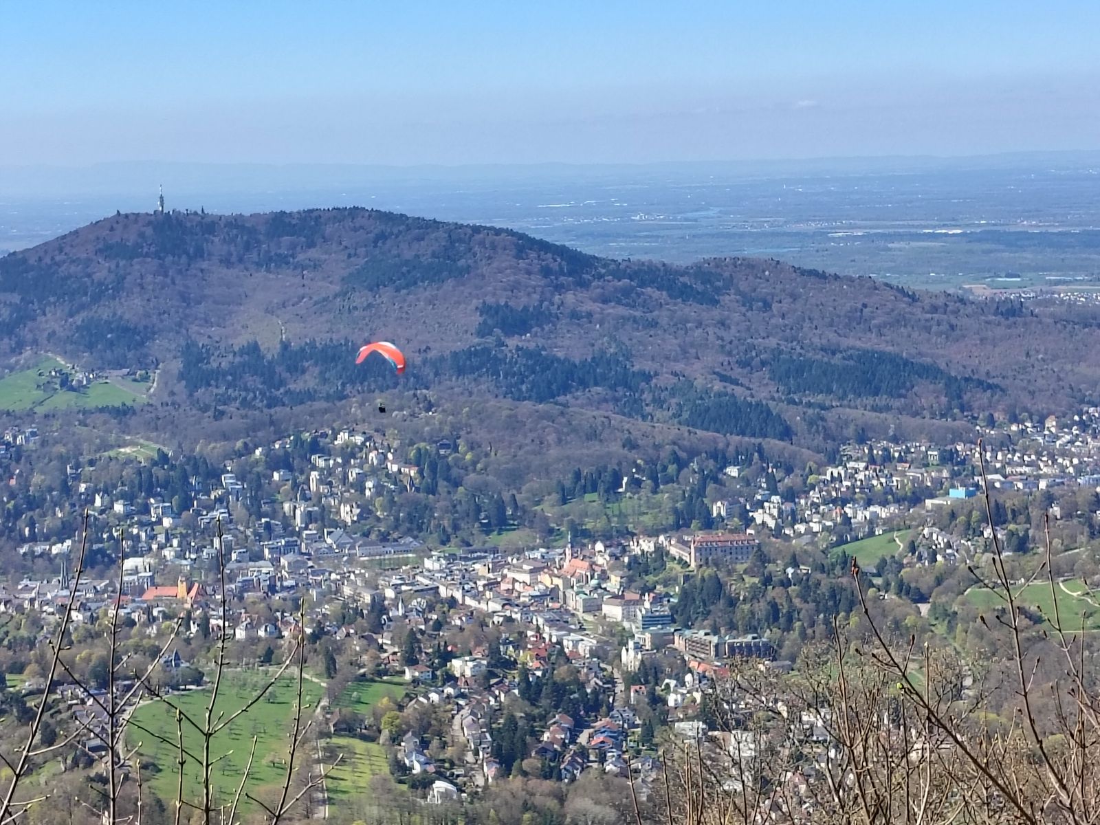 The Black Forest ridge above the town, with a paraglider off the Merkur