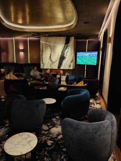 The lounge at the Steigenberger Icon Europäischer Hof — fire lit, football on, nobody in a hurry