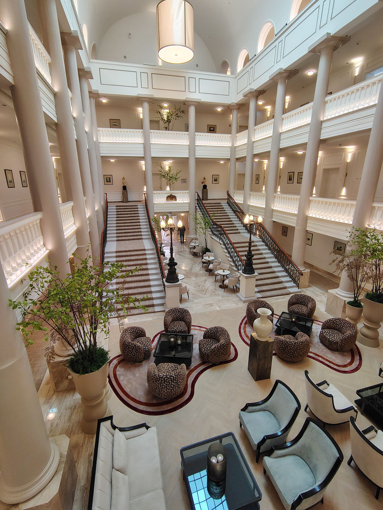 The Badischer Hof lobby, arranged around its staircases under the glass roof