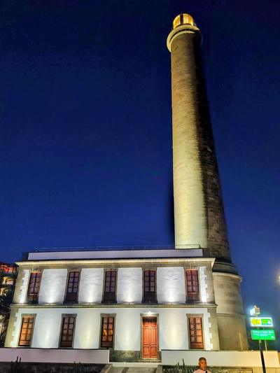 The Maspalomas lighthouse, 1890, floodlit against a blue hour sky