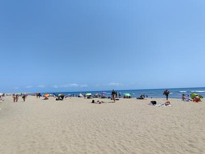 Parasols scattered down the sand in the middle of the afternoon — Maspalomas