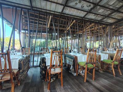 The African-themed dining room at Lopesan Baobab, laid up under a painted ceiling