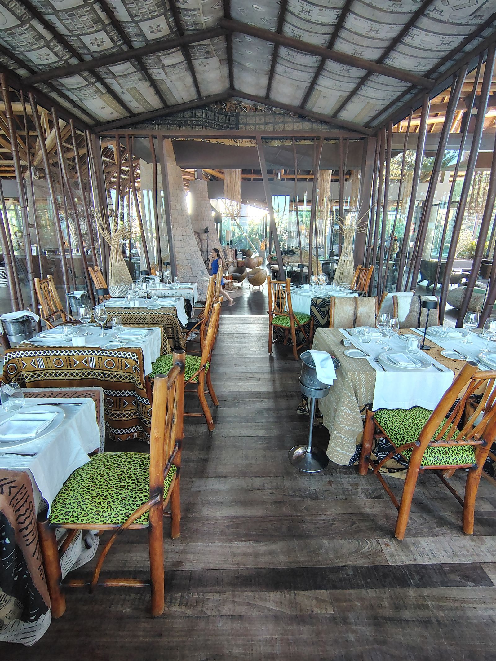 Down the length of the Lopesan Baobab restaurant, mud-cloth on every table