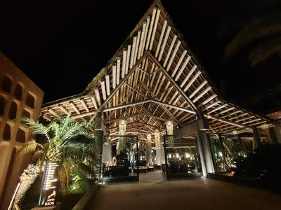 The Lopesan entrance at midnight, still lit like a stage set