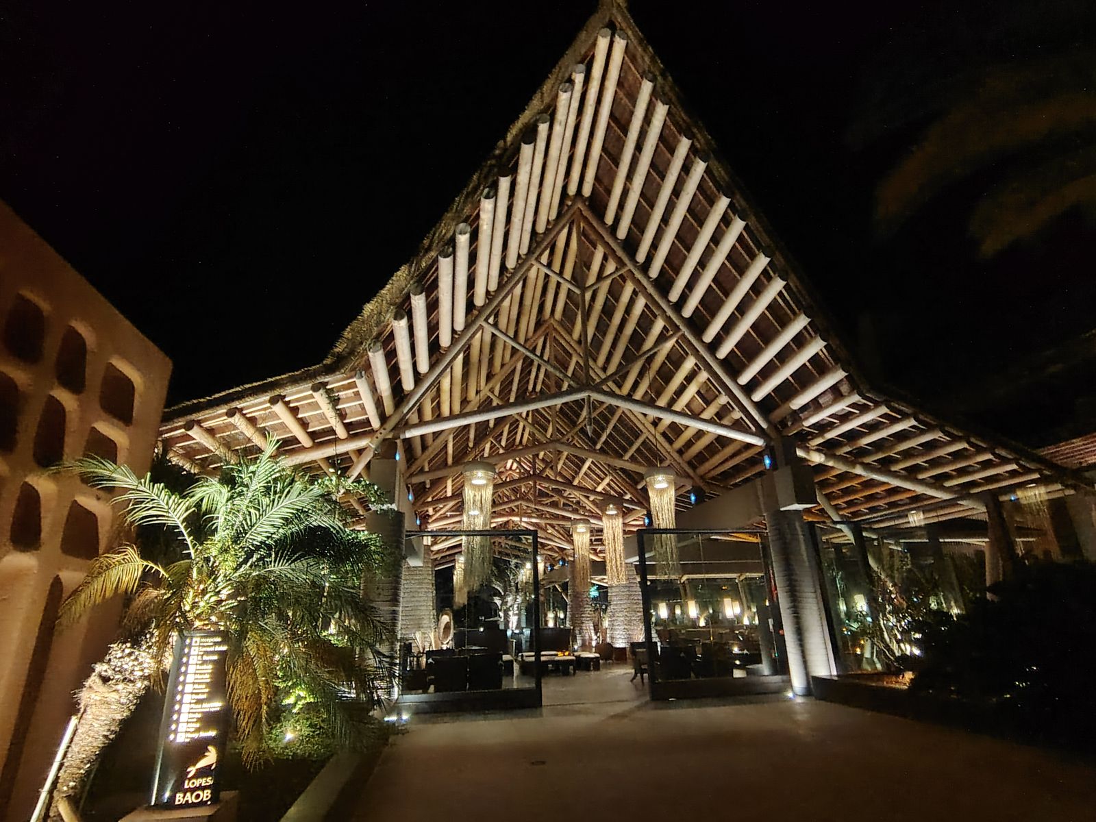 The Lopesan entrance at midnight, still lit like a stage set