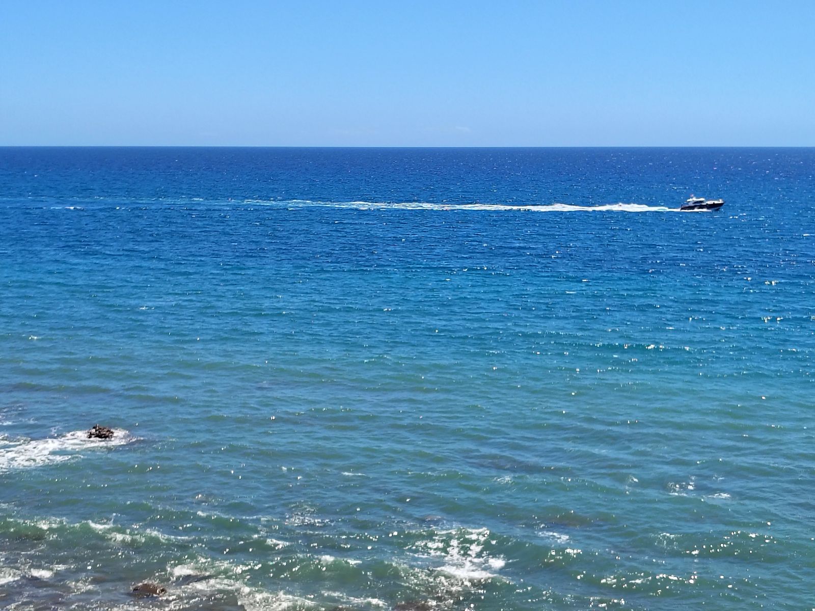 The Atlantic doing what it does, a wake crossing it