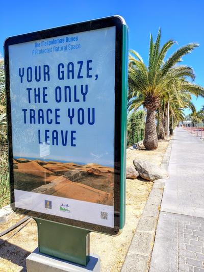A dunes-conservation sign on the promenade: your gaze, the only trace you leave