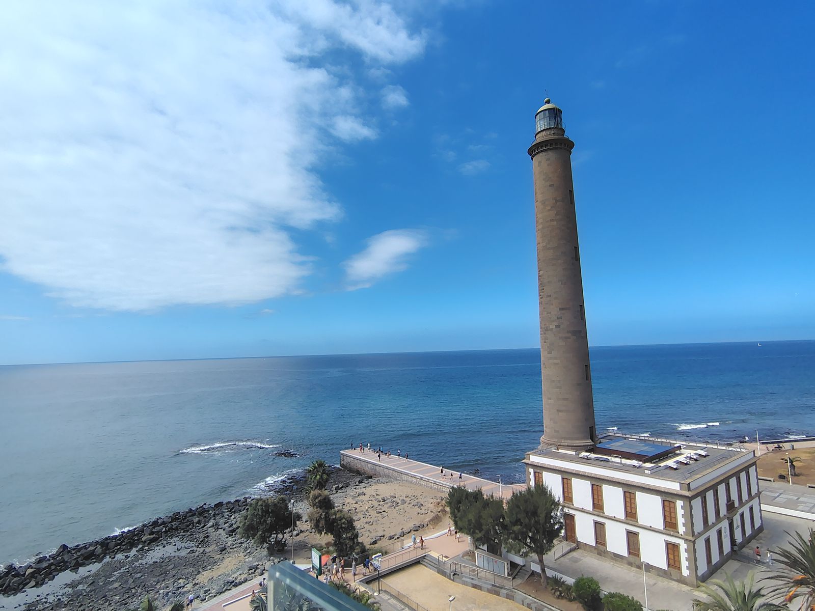 The lighthouse and its shoreline in the middle of the day