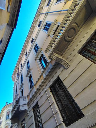 Looking straight up a painted facade, which is how most of Como is best seen