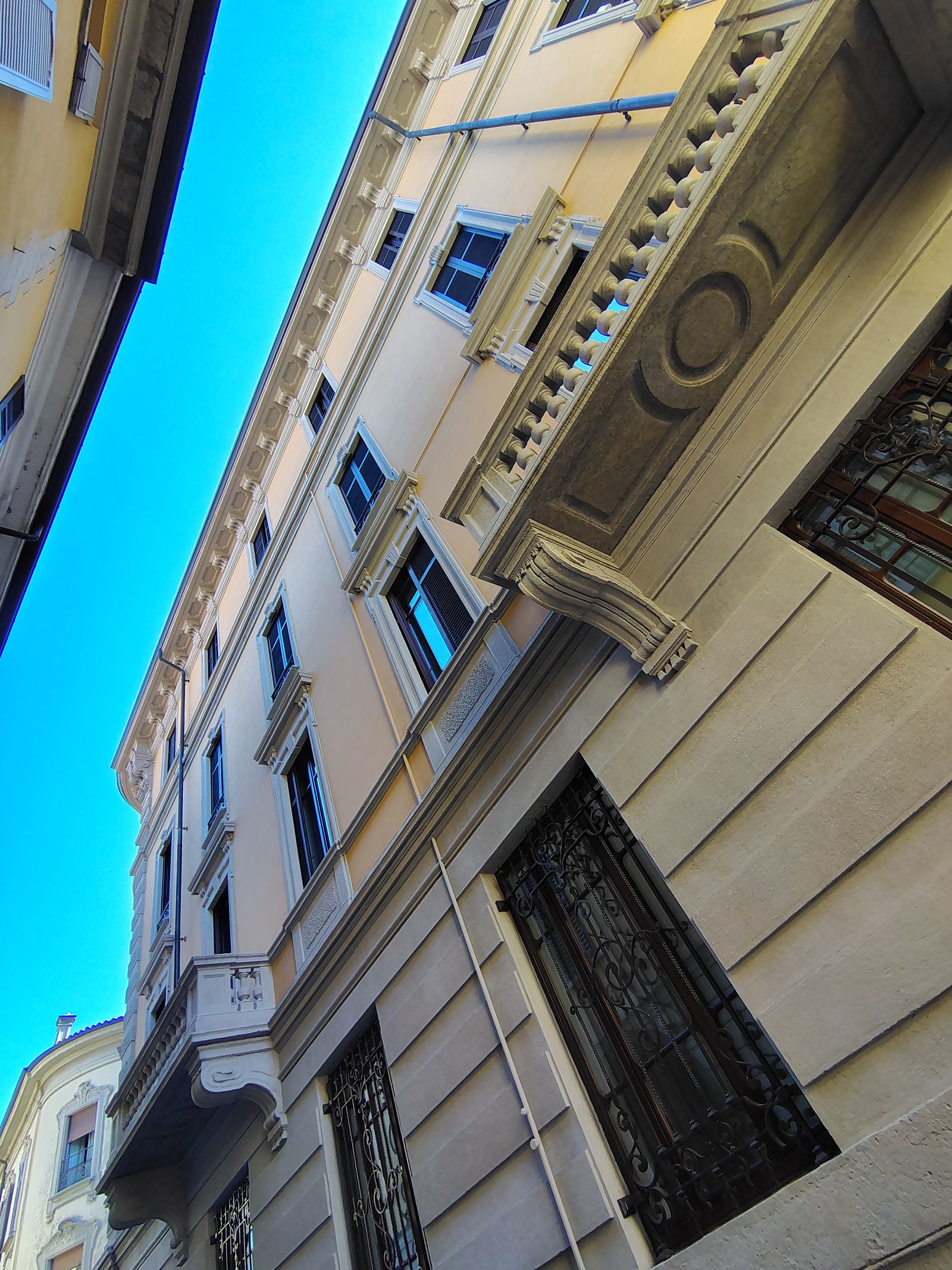 Looking straight up a painted facade, which is how most of Como is best seen