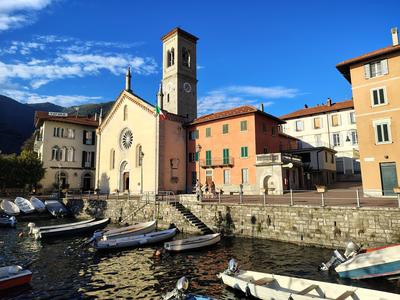 A lakeside church with the boats pulled up in front of it — Lake Como