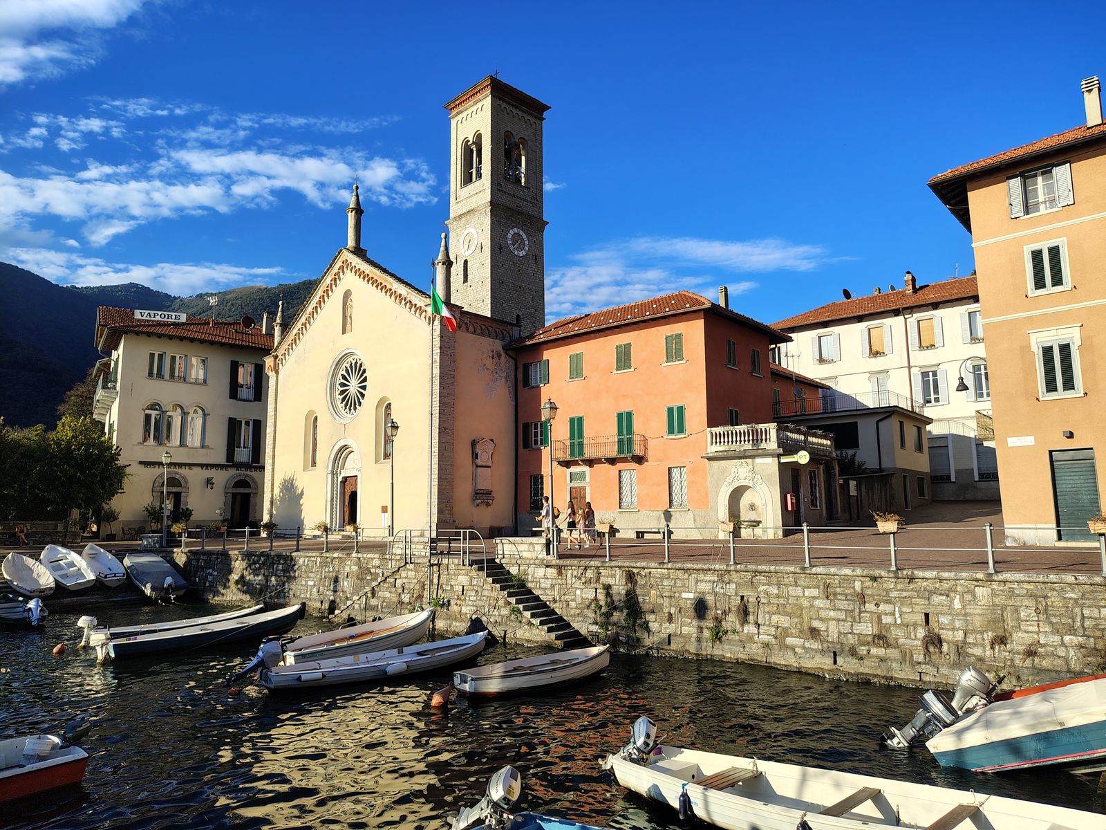 A lakeside church with the boats pulled up in front of it