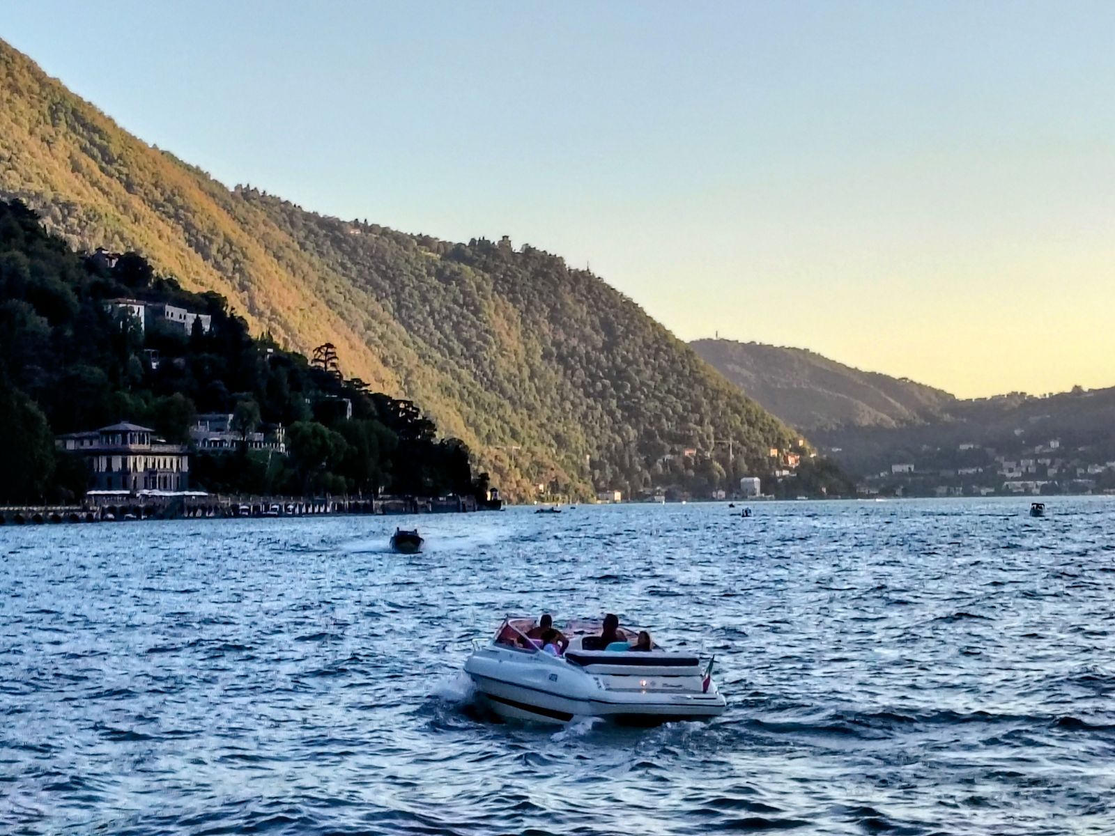 Golden hour on the water, a small boat heading home