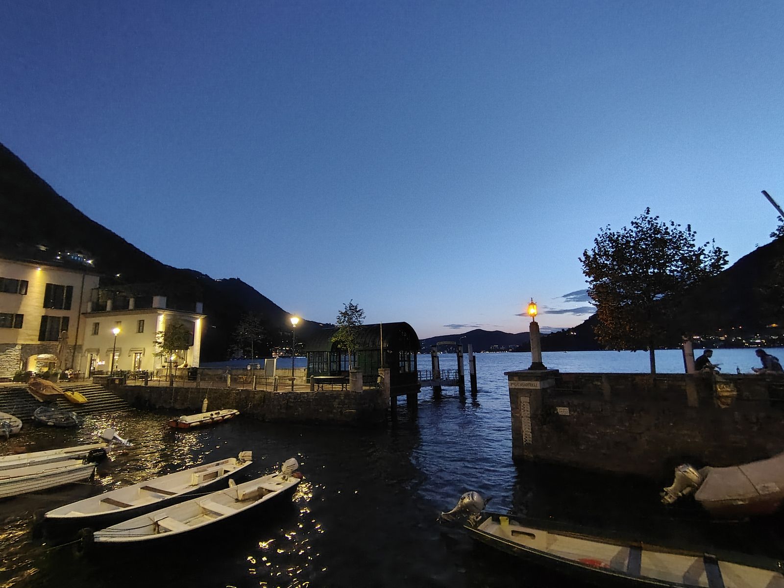 Boats and a jetty at the blue end of the evening