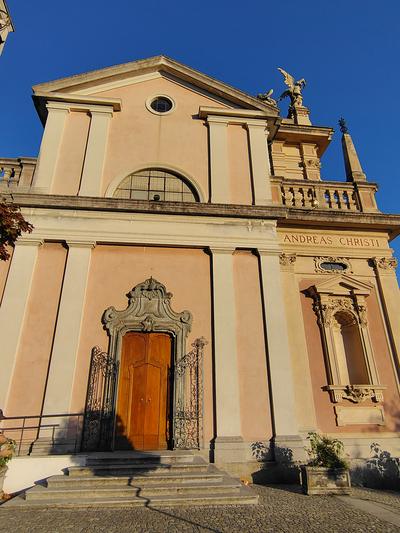 A pink church front catching the last of the sun