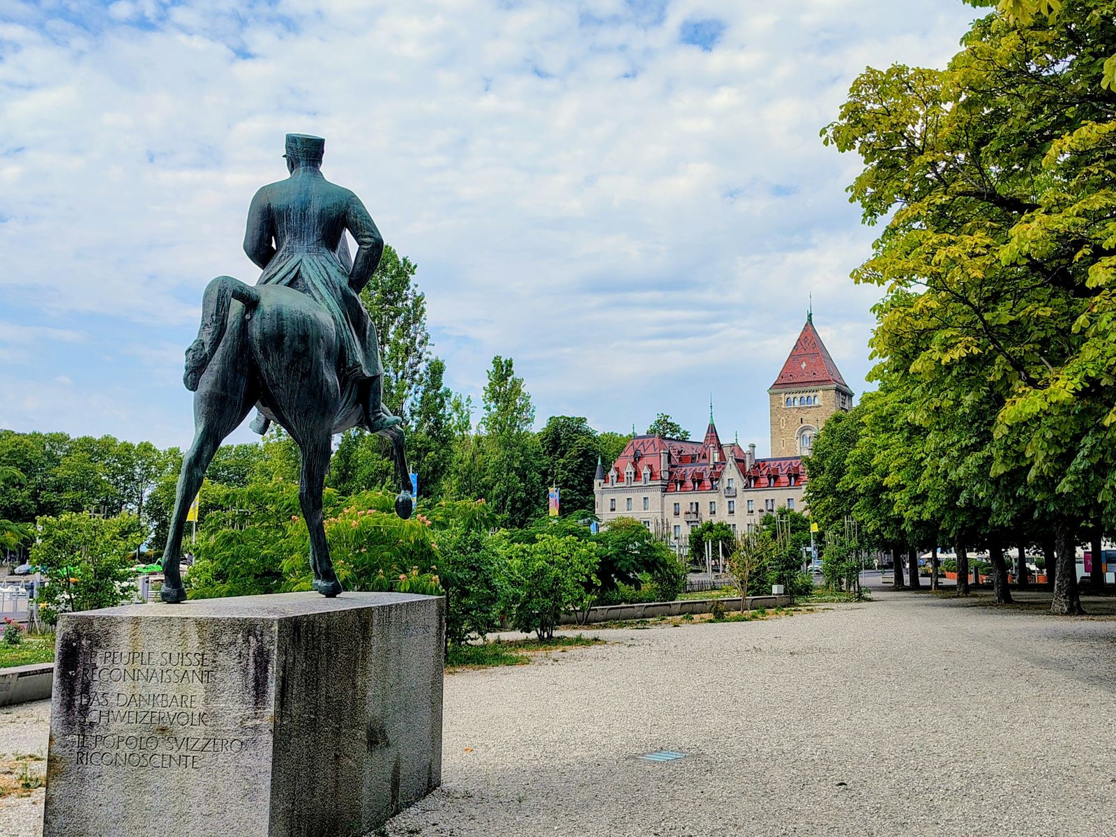 The equestrian statue in the Beau-Rivage Palace park, the Château d'Ouchy behind it