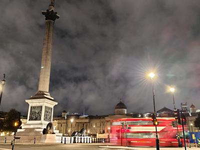 Nelson's Column in Trafalgar Square on a stormy night, a bus streaking past <strong>Our own photograph of London, not of the hotel.</strong>