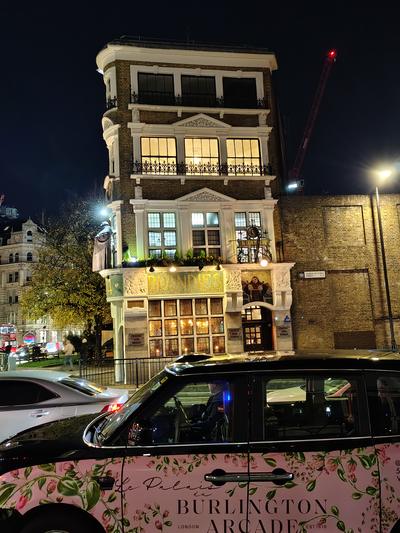 A London cab in Burlington Arcade livery on a corner near Temple