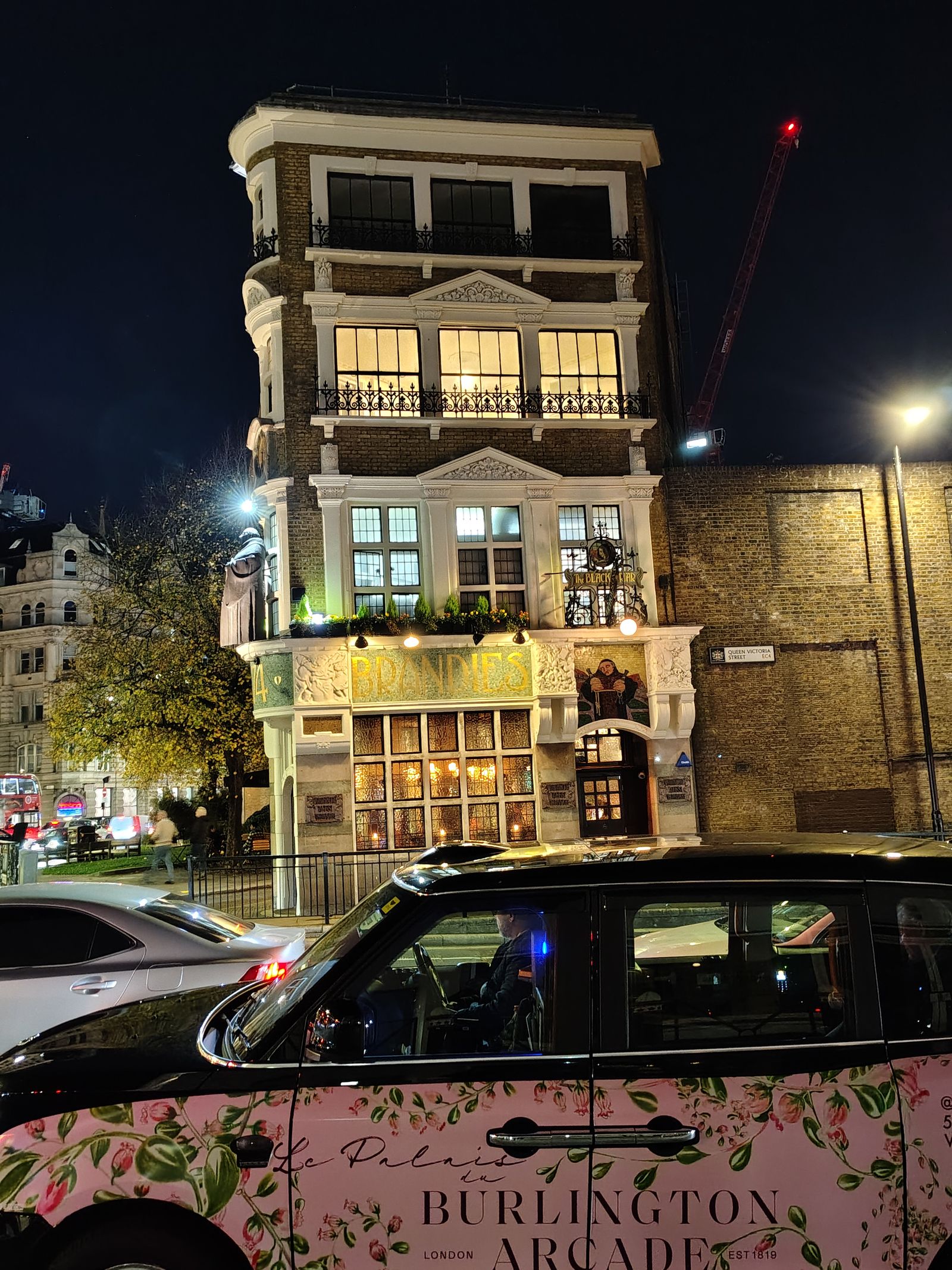 A London cab in Burlington Arcade livery on a corner near Temple