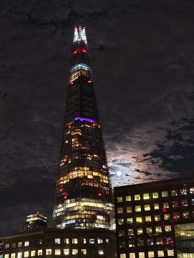 The Shard on a cloudy night, the moon breaking through