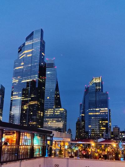 The City towers at dusk from a rooftop terrace near Bank