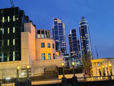 The riverside at Vauxhall at dusk, the new towers lit behind
