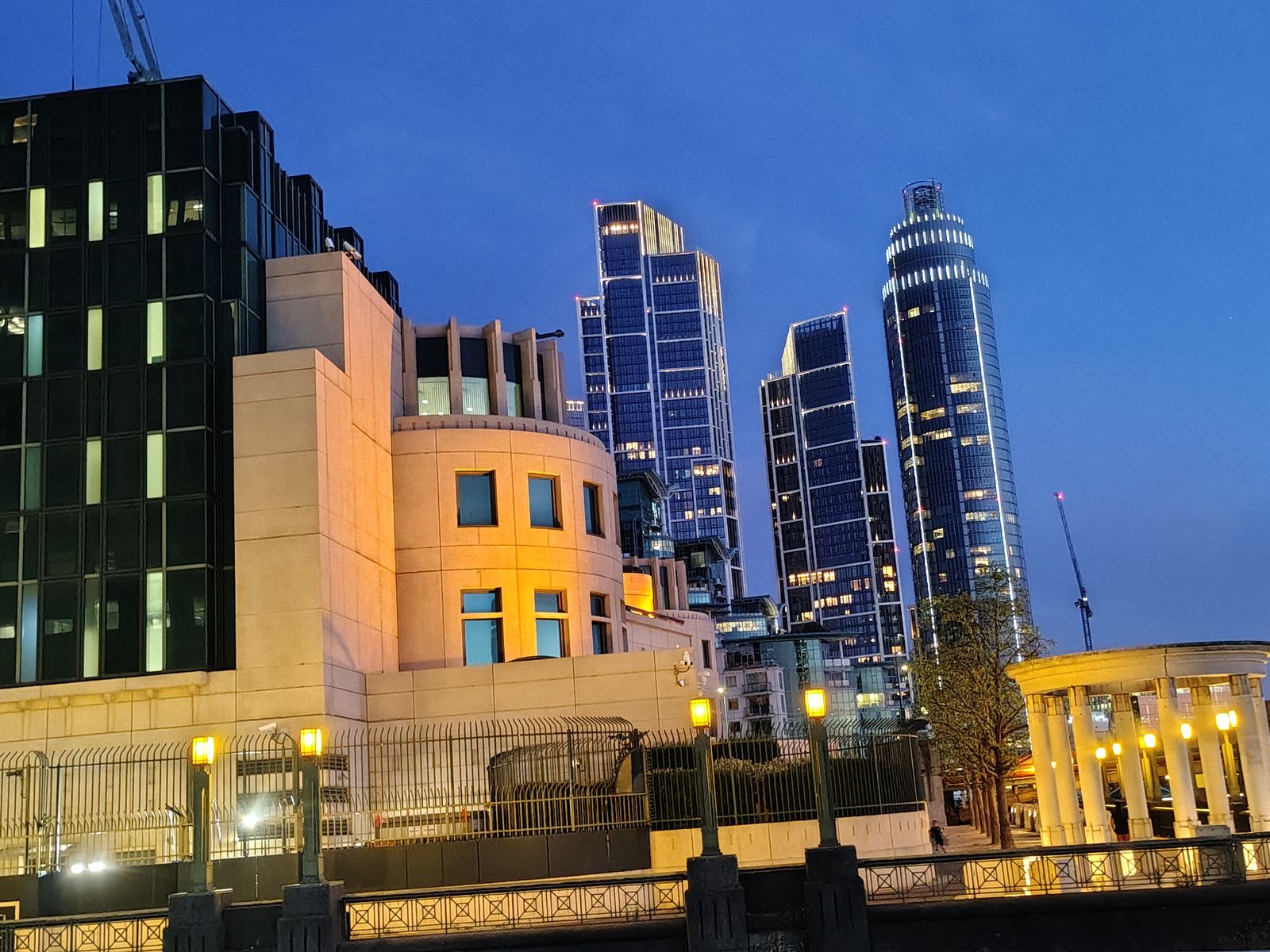 The riverside at Vauxhall at dusk, the new towers lit behind