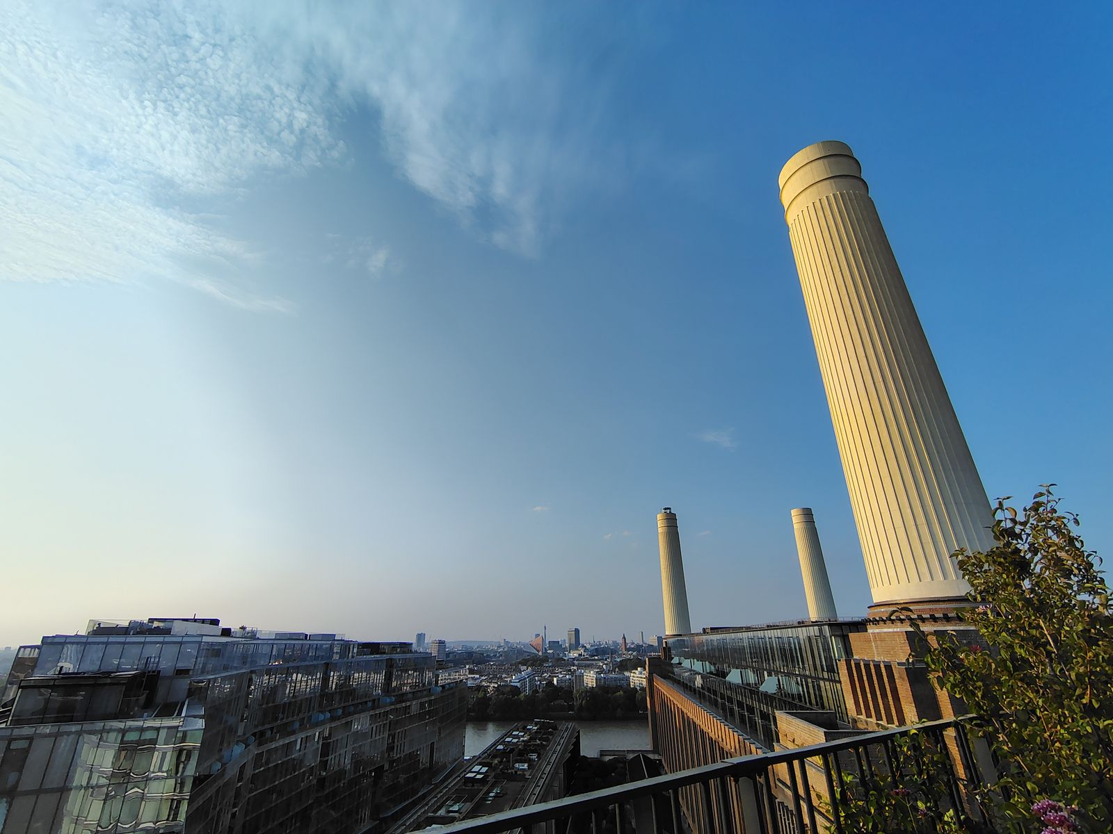 Battersea Power Station's chimneys from a roof terrace, the city spread out beyond