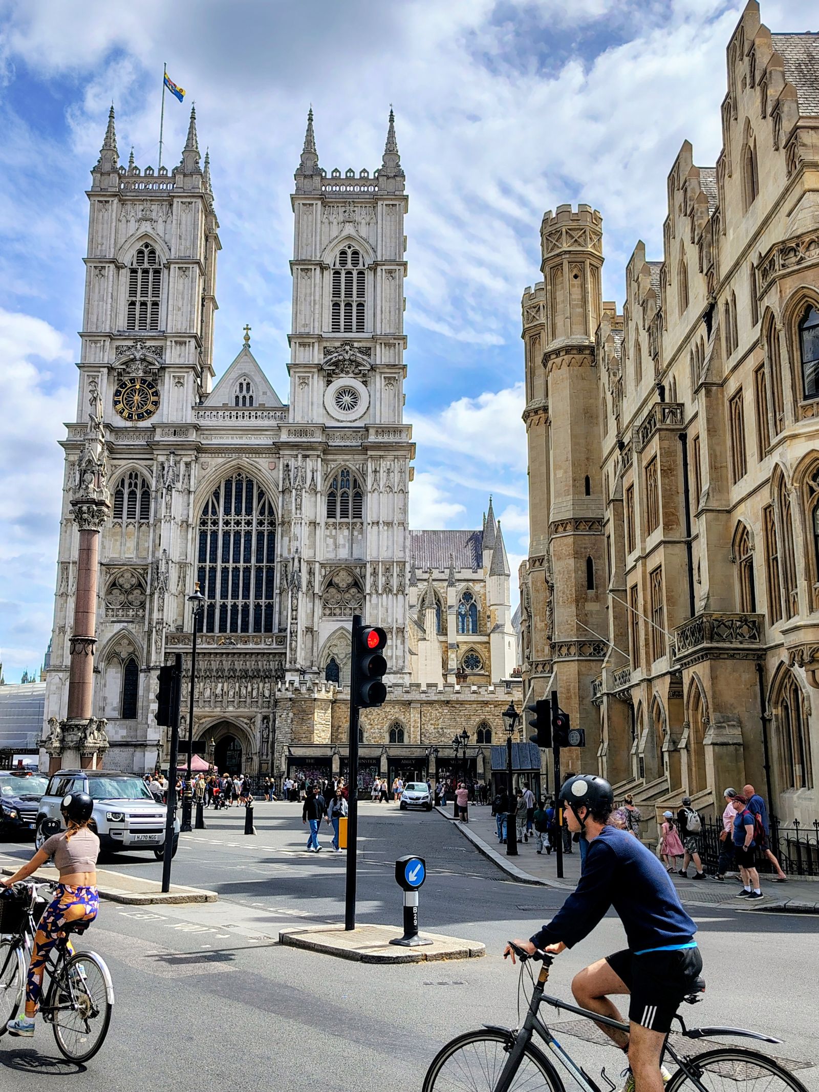 Westminster Abbey on a Saturday, cyclists waiting at the lights — London