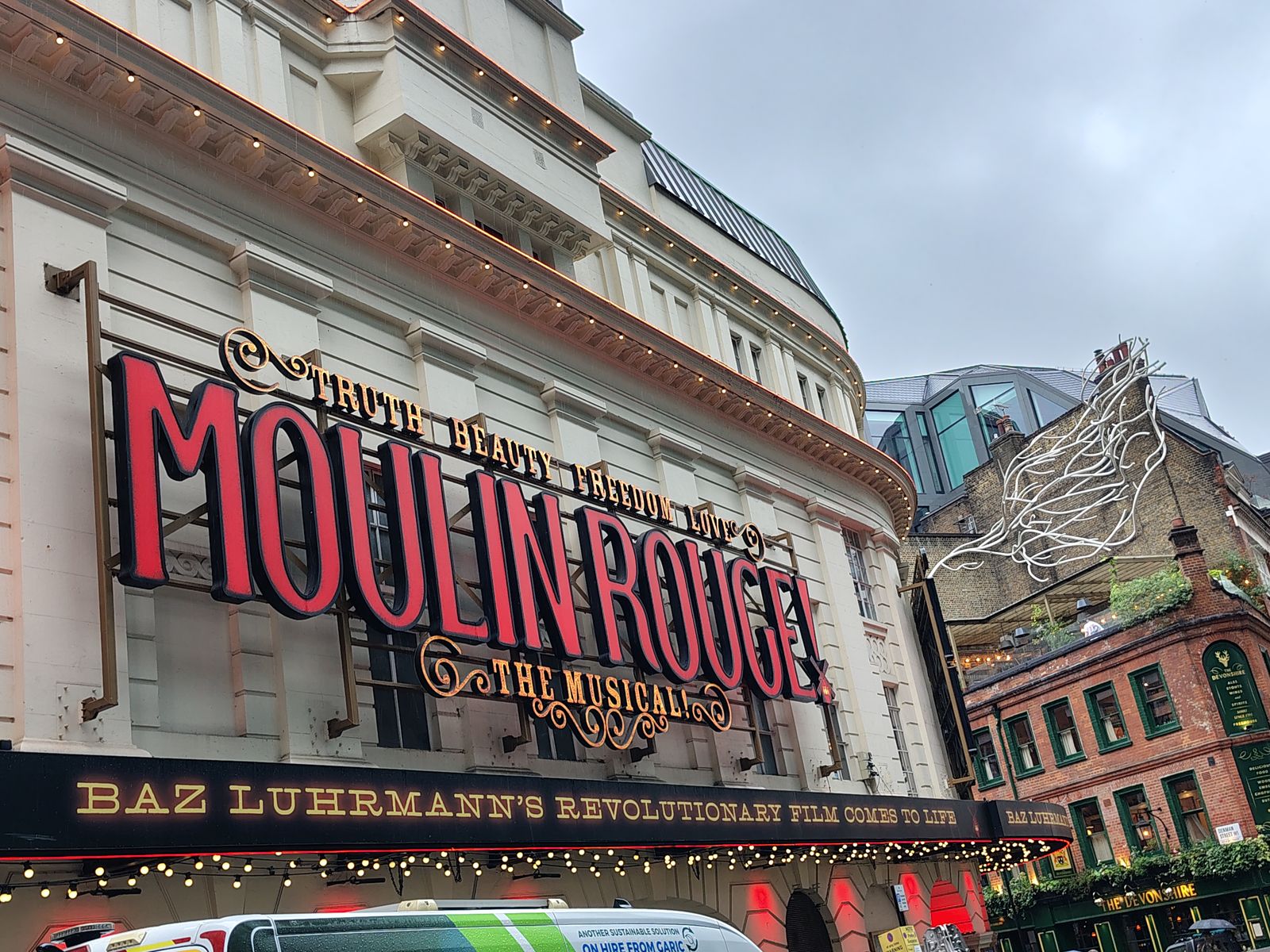Moulin Rouge in lights over the Piccadilly Theatre