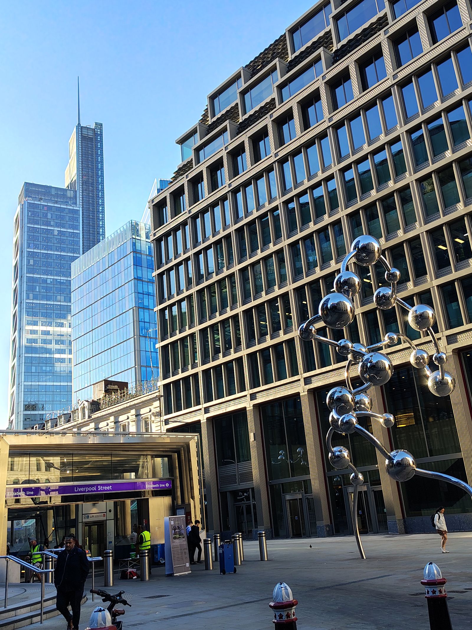 The Elizabeth line entrance at Liverpool Street, the City towers rising behind