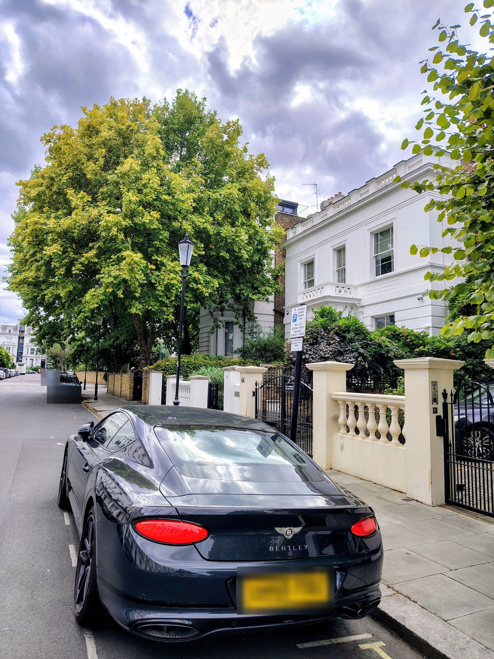 A white villa on a Notting Hill street, a Bentley at the kerb