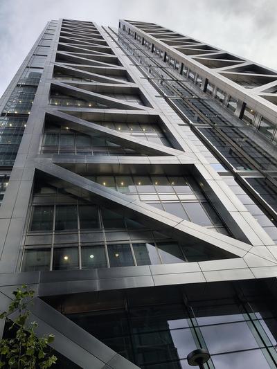 Looking straight up a City tower on a grey afternoon — London