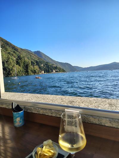 An aperitivo at Il Belvedere itself, the lake and the far shore framed by the window.