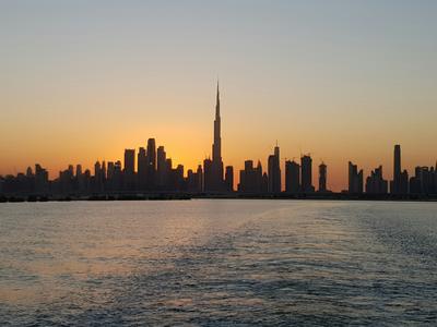 The skyline across the water at sunset — Dubai