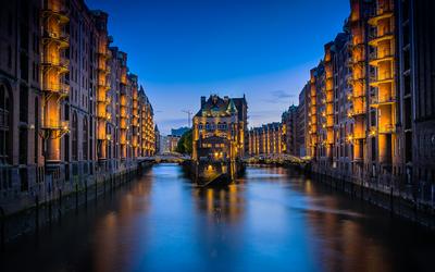 A canal through the Speicherstadt warehouses at night — Hamburg