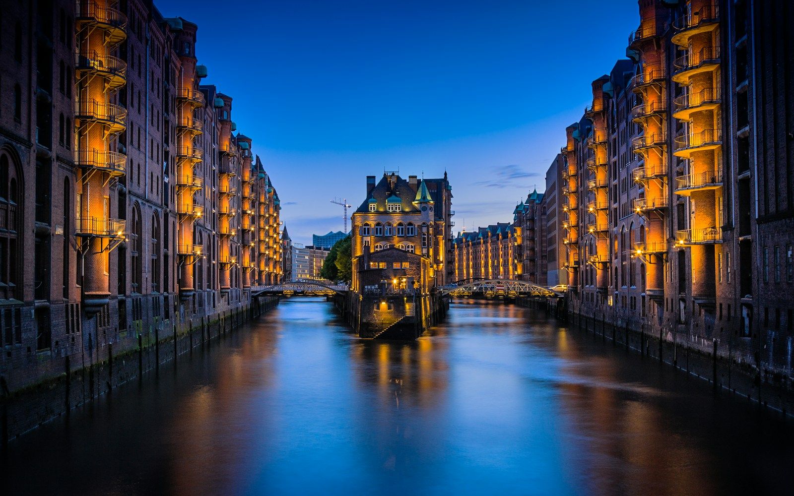 A canal through the Speicherstadt warehouses at night — Hamburg
