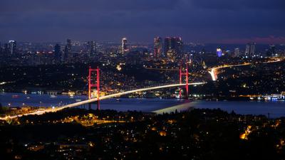 The city and its bridge after dark — Istanbul