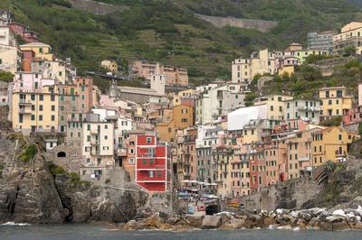 Houses stacked up the hillside above the water — the Italian Riviera