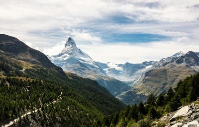 Alpine slopes and larch above the valley — the Valais Alps