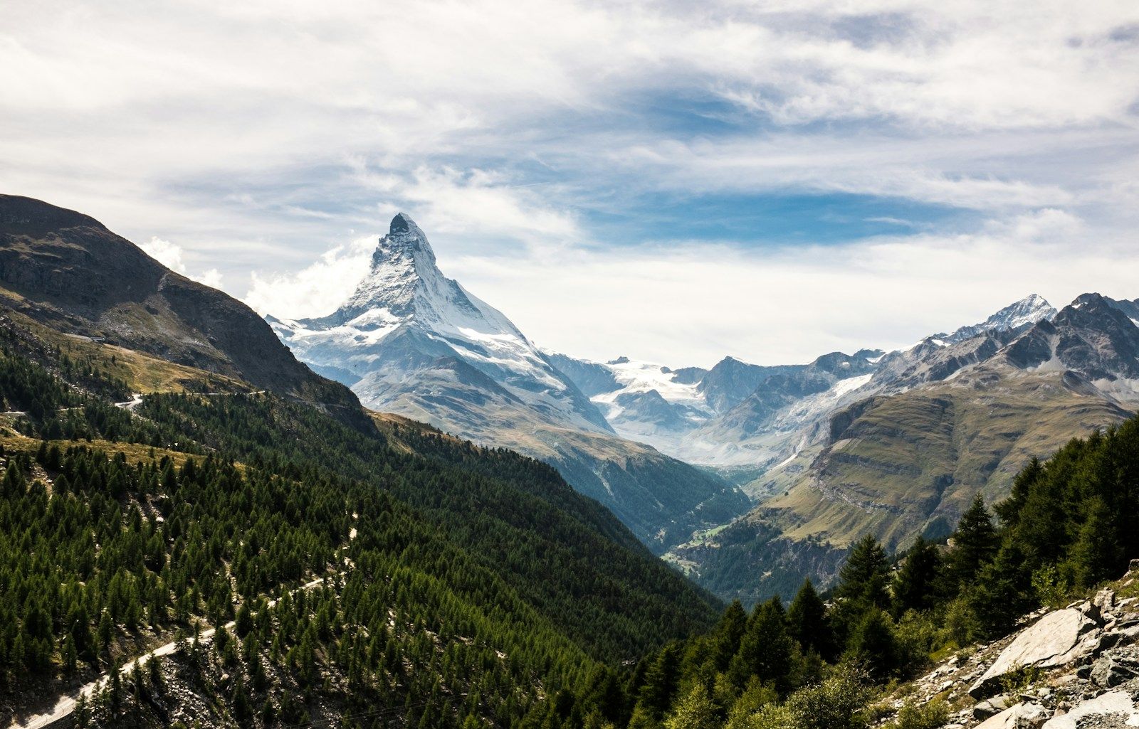 Alpine slopes and larch above the valley — the Valais Alps
